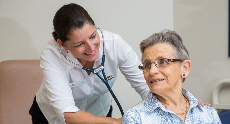 Nurse Practitioner assessing resident Joan